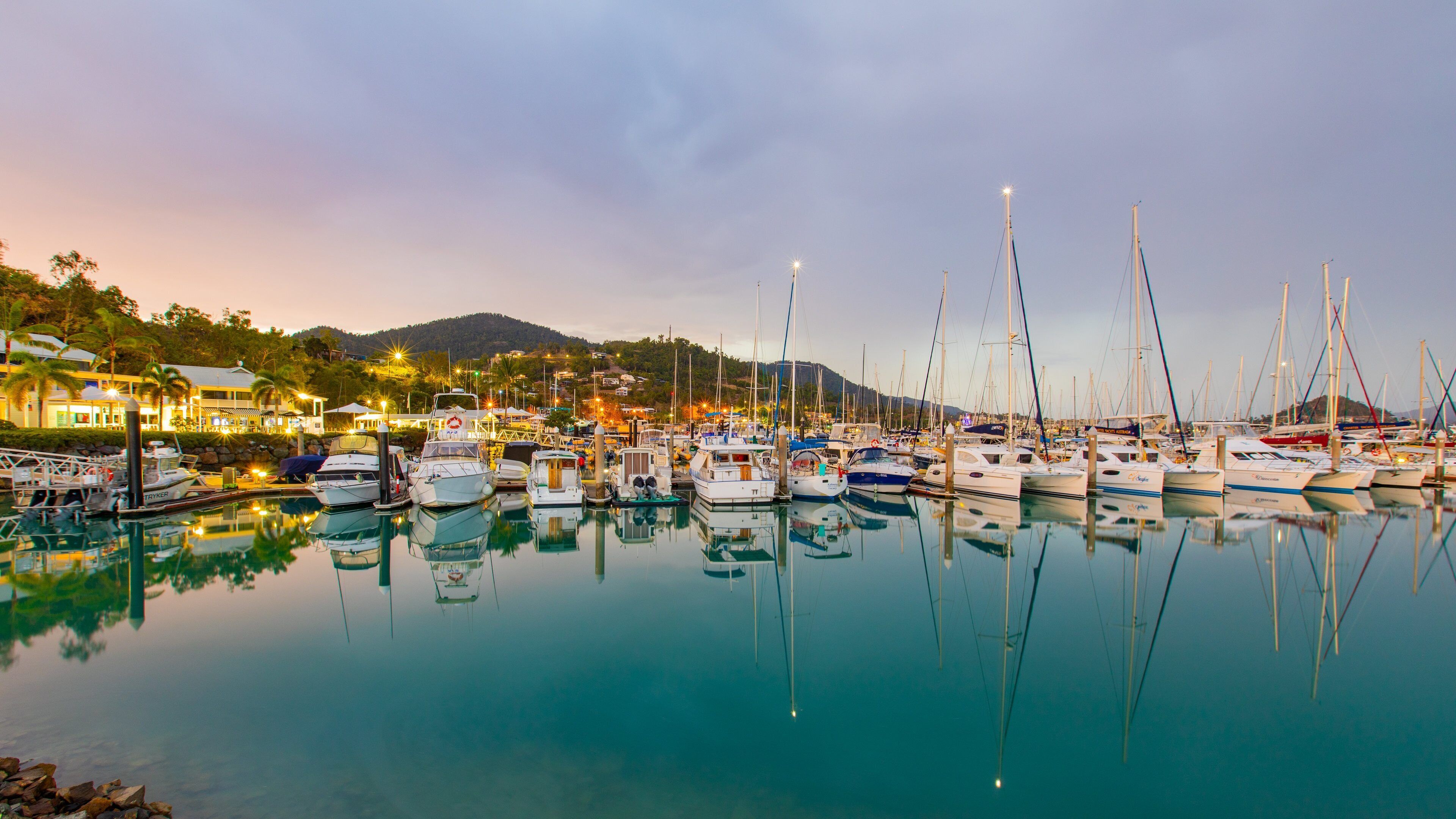 Coral Sea Marina featuring a bay or harbor and a sunset