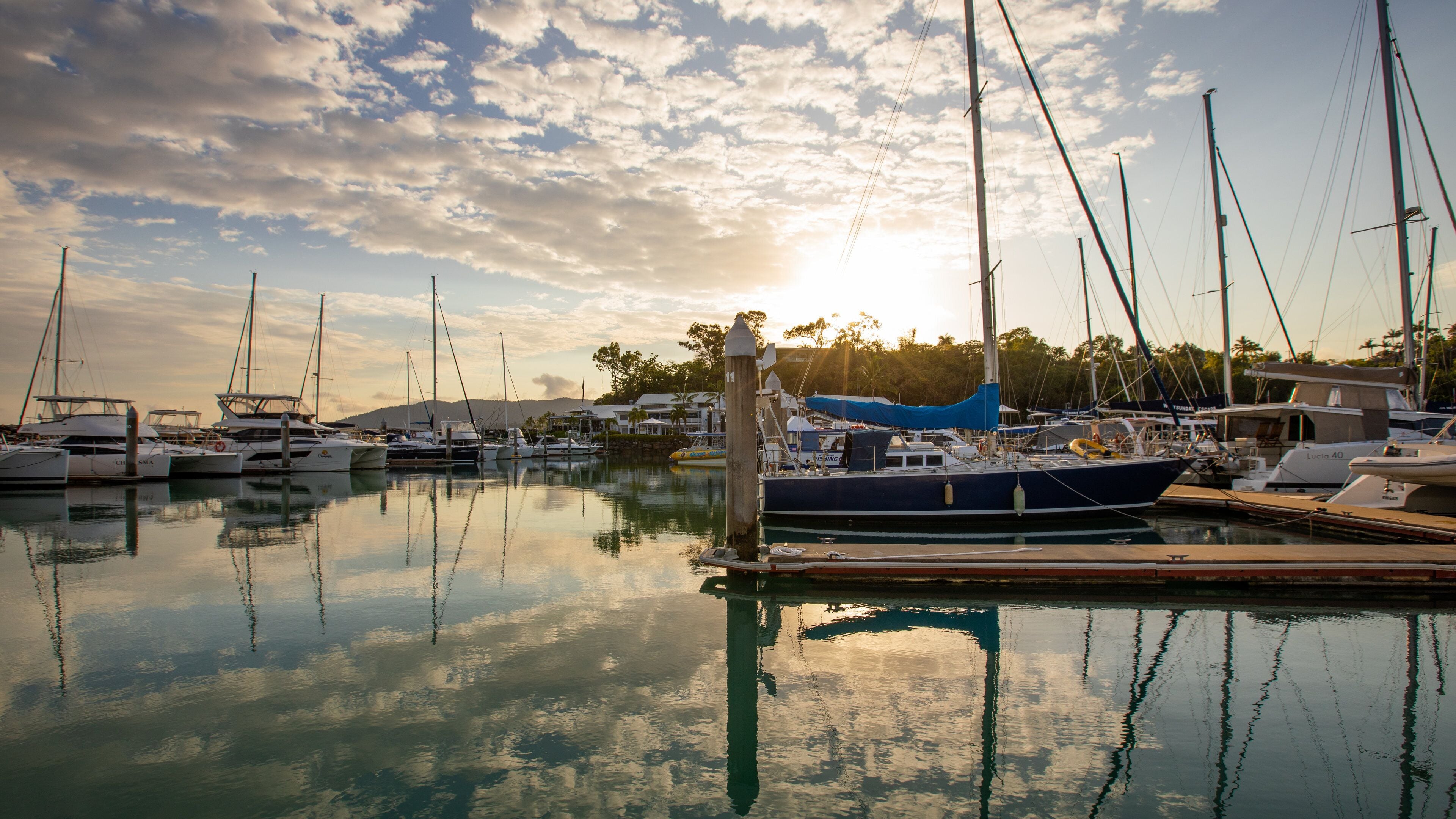Coral Sea Marina which includes a sunset and a bay or harbor