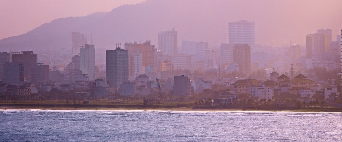 Son Tra Mountain showing mist or fog and a coastal town