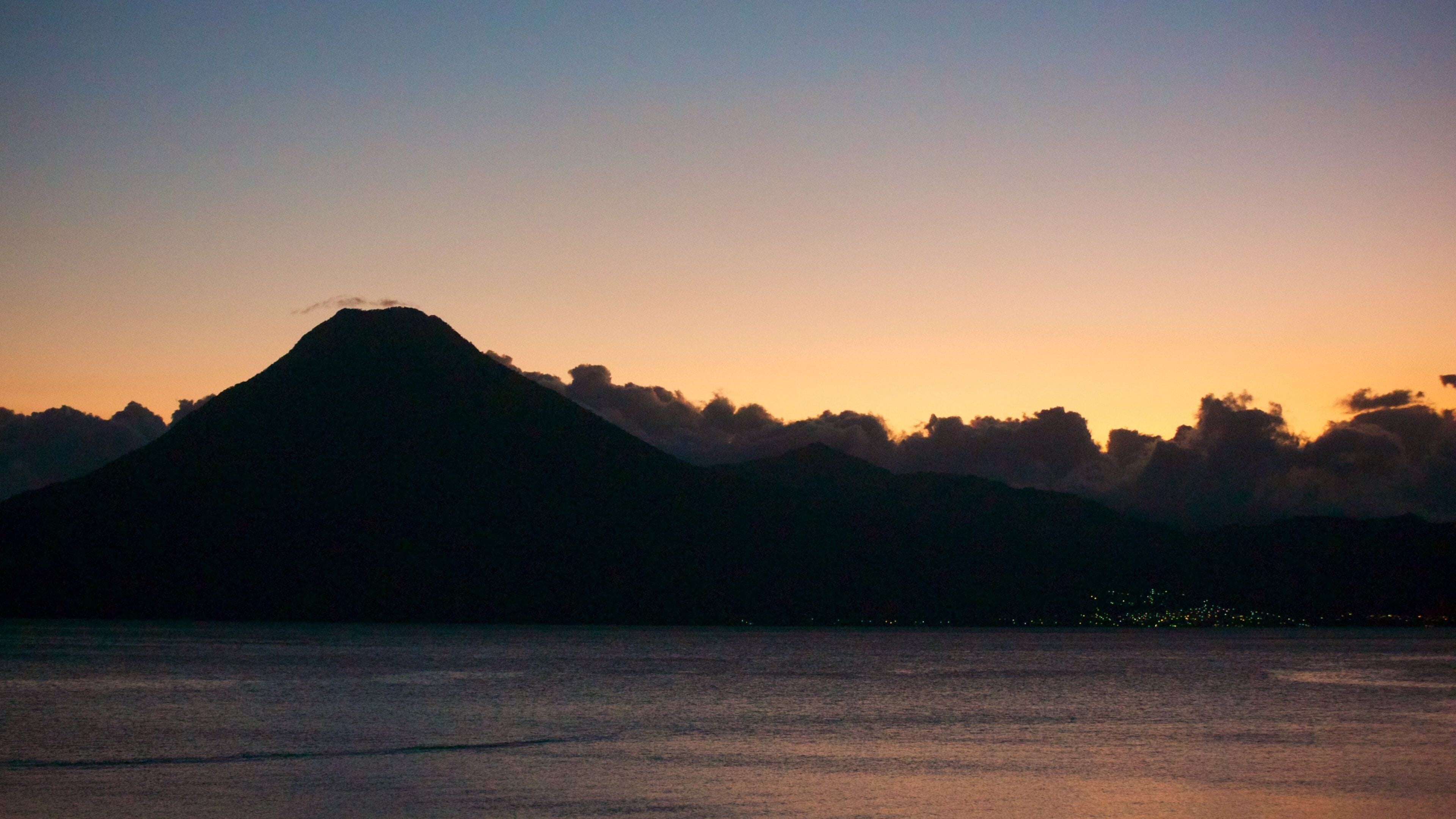 San Juan La Laguna which includes general coastal views and a sunset