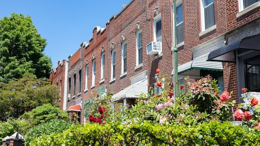 Row of Old Brick Homes with Beautiful Gardens with Flowers during Spring in Sunnyside Queens New York
