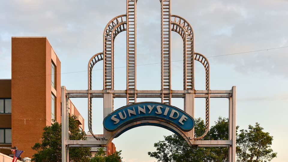 A roller coaster structure with the word "SUNNYSIDE" on it.