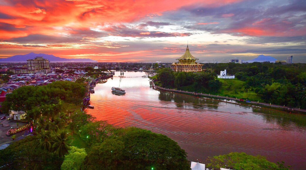 Kuching which includes a river or creek, a sunset and landscape views