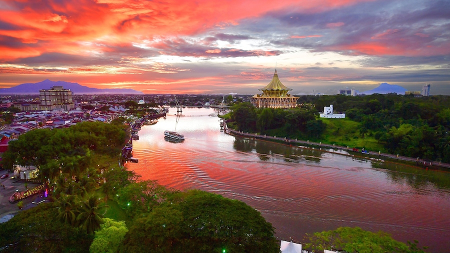 Kuching which includes a river or creek, a sunset and landscape views