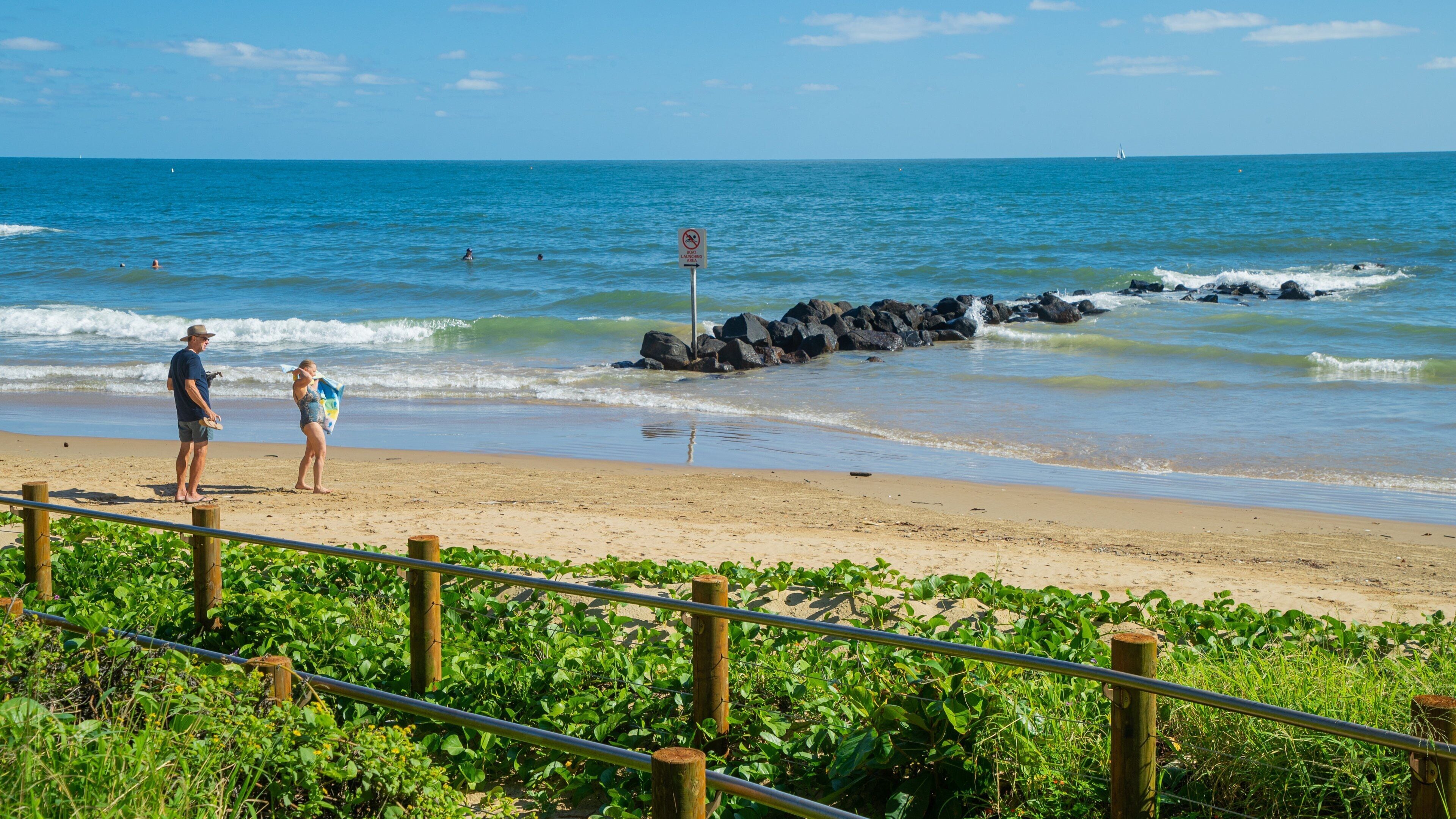 Bargara Beach which includes general coastal views and a sandy beach as well as a couple