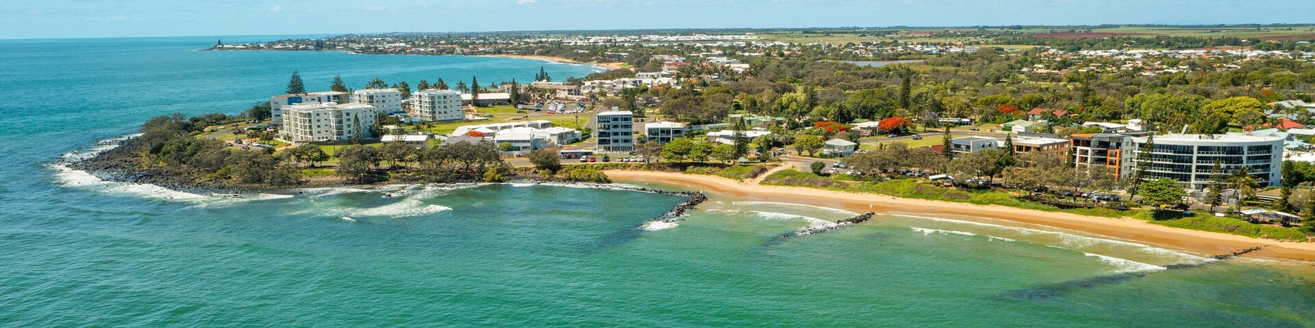 Bargara Beach showing landscape views, general coastal views and a coastal town