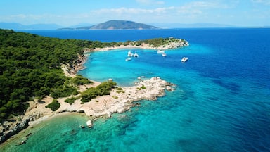 Aerial drone ultra wide photo of paradise small island of Moni visited by sail boats and yachts with turquoise clear seascape, Aegina island, Saronic gulf, Greece