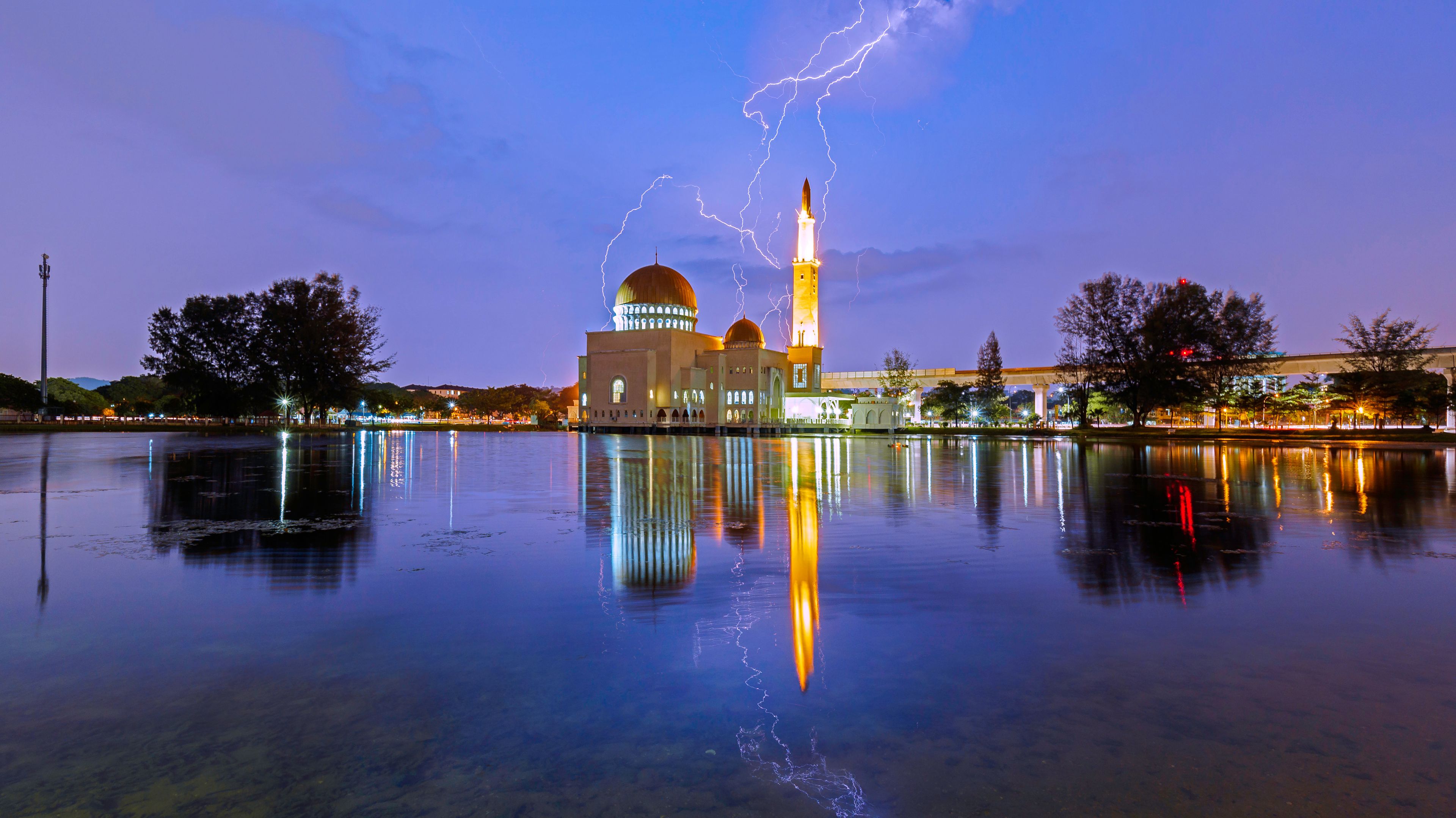 Amazing lightning scene over al-Salam Mosque at Puchong Perdana, Kuala Lumpur, Malaysia with reflection by lake.