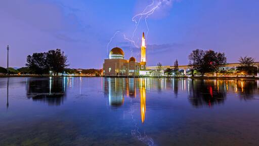 Amazing lightning scene over al-Salam Mosque at Puchong Perdana, Kuala Lumpur, Malaysia with reflection by lake.