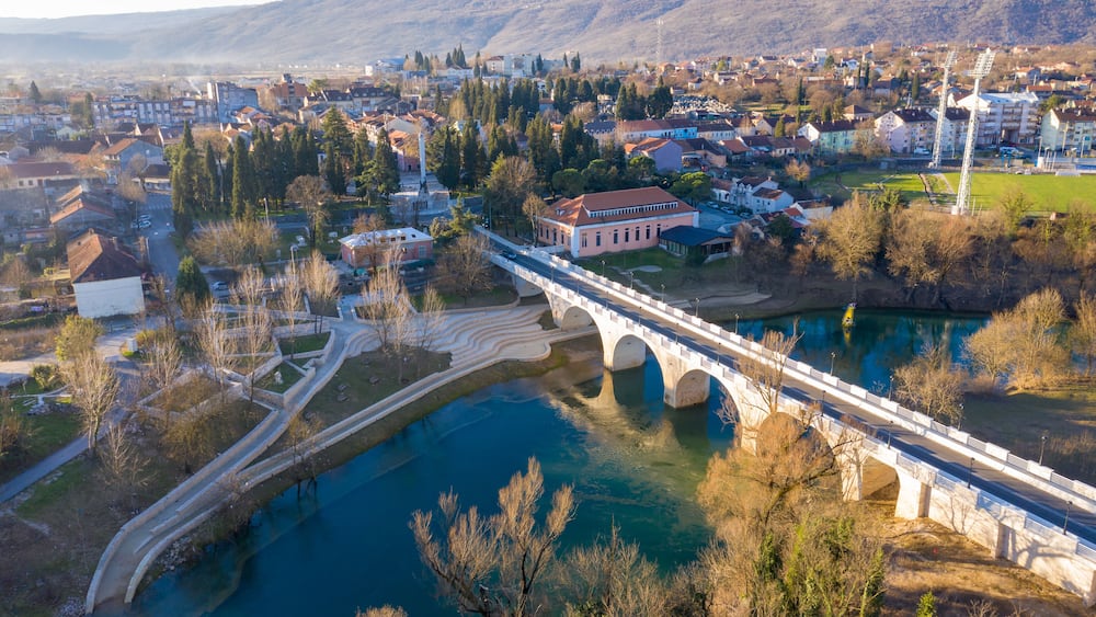 Danilovgrad Montenegro: bridge on Zeta river on the way to Ostrog monastery and the downtown park. Aerial view of the small town in Bjelopavlici.