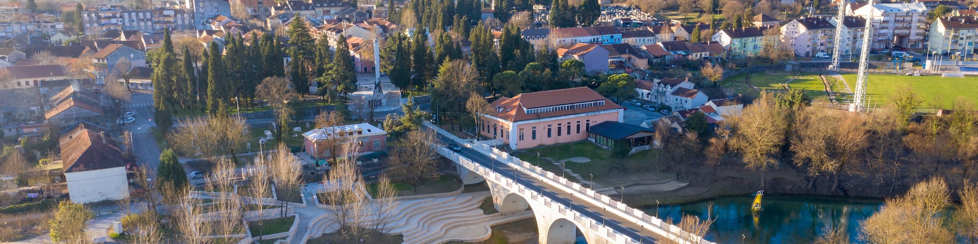 Danilovgrad Montenegro: bridge on Zeta river on the way to Ostrog monastery and the downtown park. Aerial view of the small town in Bjelopavlici.