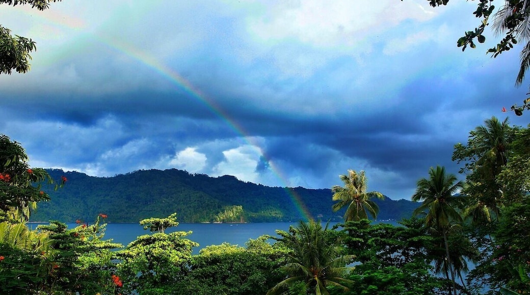 • Rainbow in Paradise •
There is a verse in the bible that tells us, "I have set my rainbow in the clouds, and it will be the sign of the covenant between me and the earth." (Gen 9:13)
I was lucky to spot such a wonderful divine and natural phenomenon in this place and it was so beautiful.
The island is called Lembeh Island, the strait is called Lembeh Strait and the place i took this picture is from a cozy bungalow at Black Sand Dive Retreat.