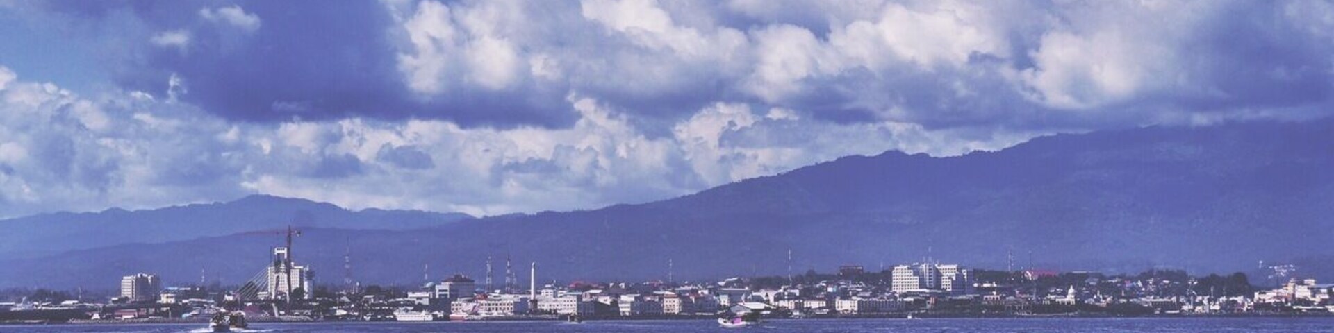 •First Post•
This city is called Manado, located in North Sulawesi, Indonesia.
This is the most populous city in North Sulawesi making this city as the capital city that has more than half a million inhabitants residing here.
It's a friendly city serving as the welcome gate to the land of waving coconuts.
Although it's not the most beautiful city in Indonesia, the city is ranked top 5 on human index development score in Indonesia.
This city is messy but it is surrounded with amazing places like beautiful beaches, magnificent volcanoes, national marine parks, tropical rainforest, incredible natural reserves and ancient living historical places.
Places to live?
I personally suggest you to live in a beach or island resort for some incredible experiences. I suggest you to look it up on Tripadvisor for some reviews!
How to get to North Sulawesi?
- There are several domestic routes from Jakarta, Surabaya, Denpasar (transit Makassar) and other cities to Manado with Garuda Indonesia, BatikAir, LionAir, SriwijayaAir, and some other domestic carriages.
- There is one international flight (five times a week) from Singapore to Manado with SilkAir.
