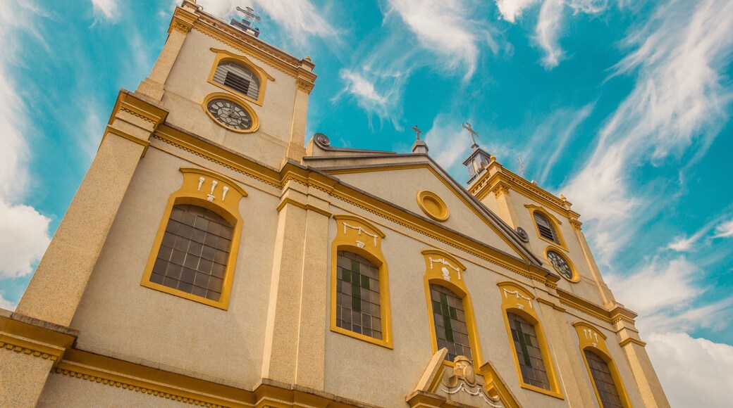 Brazilian catholic church with yellow details and blue sky with white clouds - Porto Feliz, São Paulo - Brazil