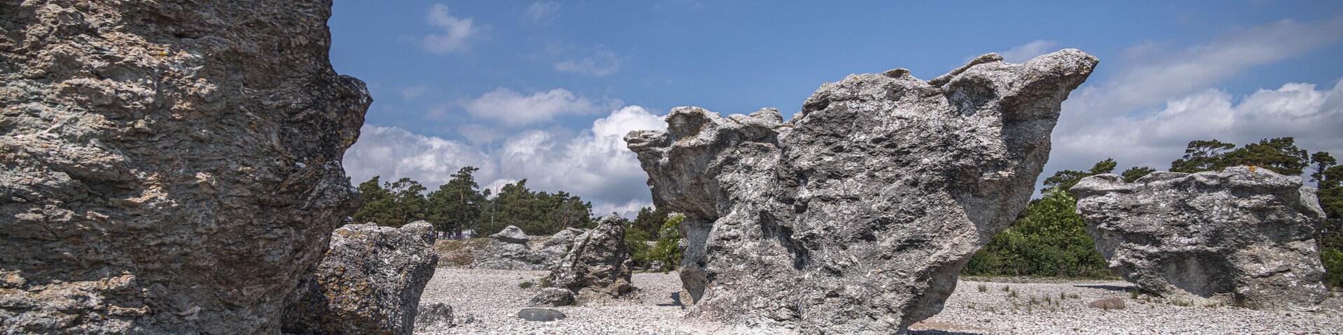 A rocky landscape with prominent rock formations and a clear blue sky.