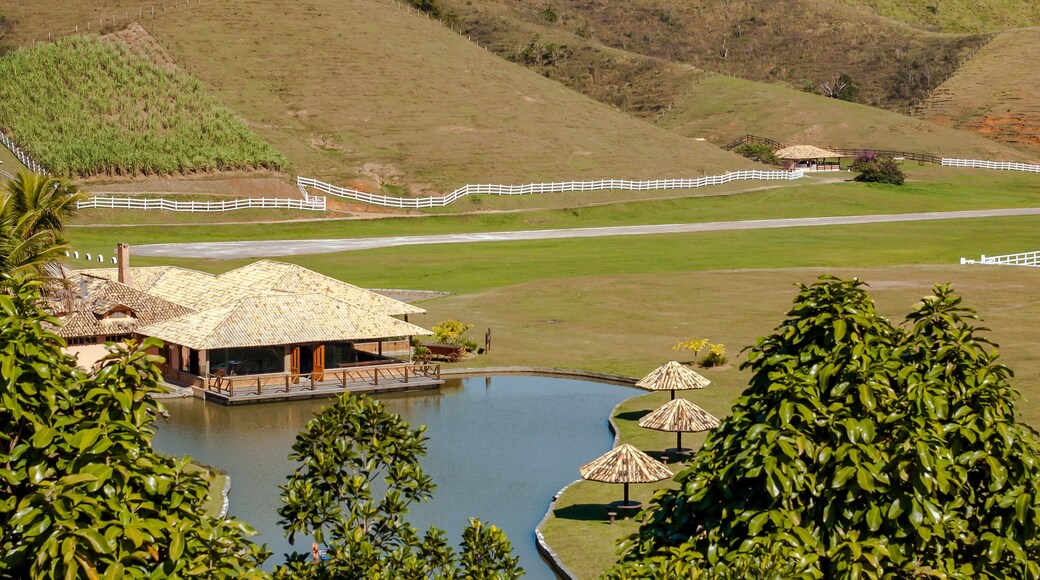 House and kiosks around a small lake, with trees and large pasture, Barra do Pirai, Rio de Janeiro, Brazil