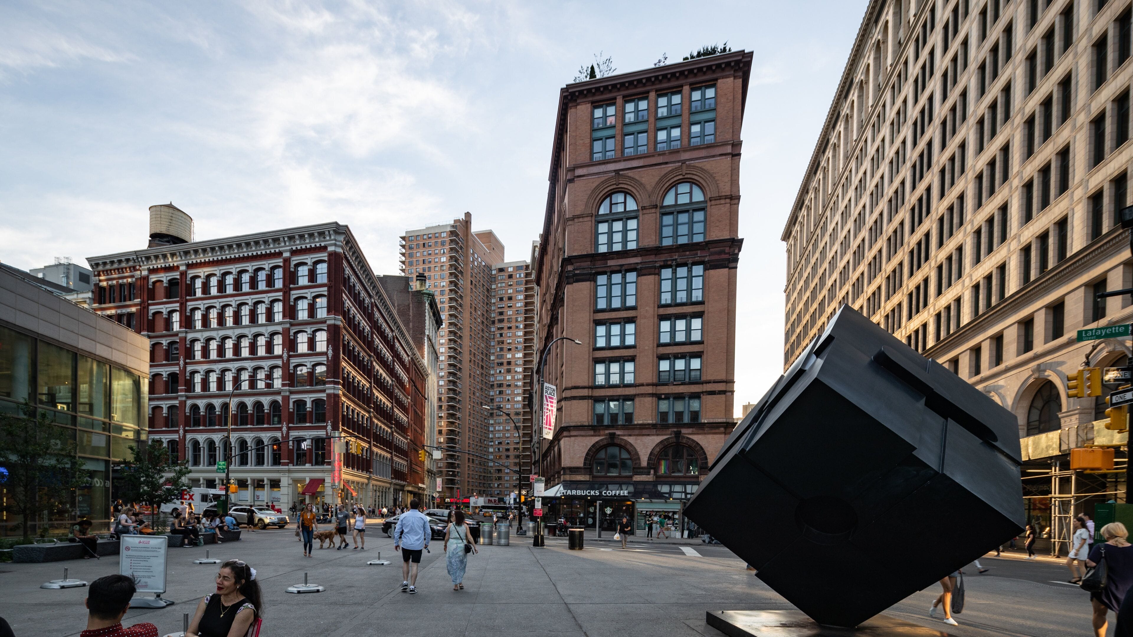 East Village which includes outdoor art, a square or plaza and a sunset