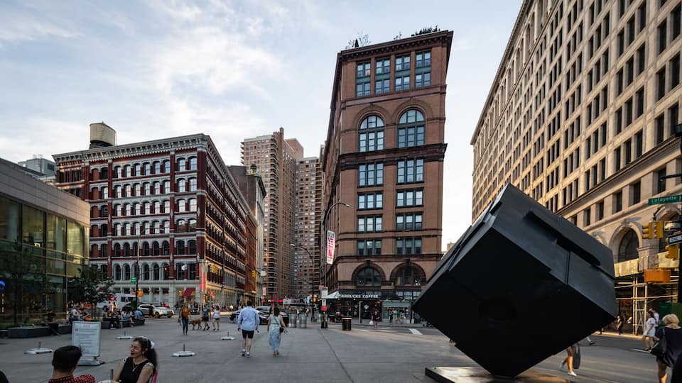 East Village which includes outdoor art, a square or plaza and a sunset