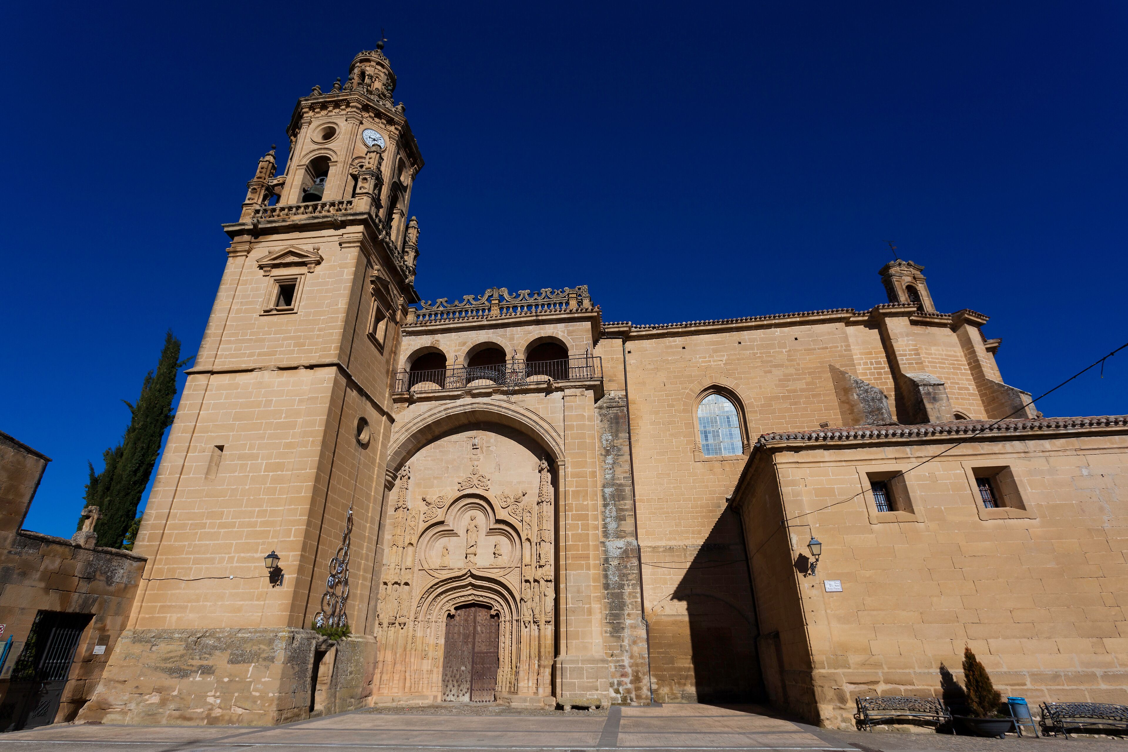 A historic church with a prominent bell tower and ornate entrance.
