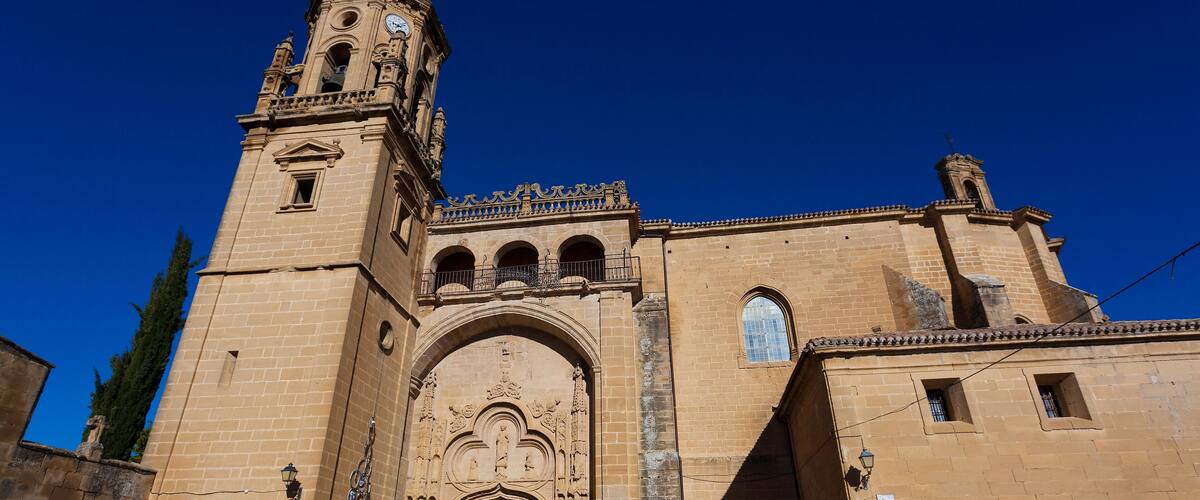 A historic church with a prominent bell tower and ornate entrance.