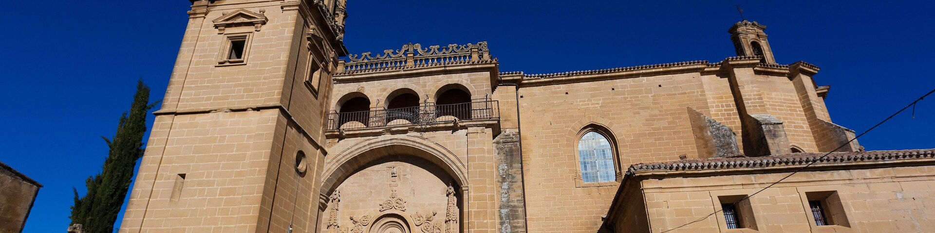 A historic church with a prominent bell tower and ornate entrance.