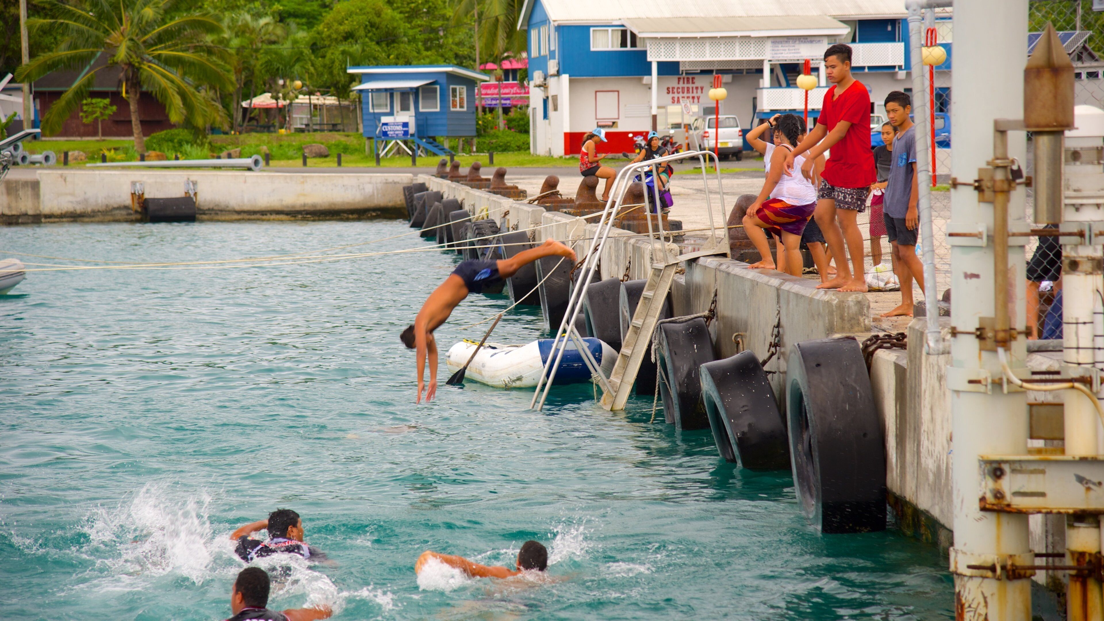 Avarua showing swimming as well as a small group of people