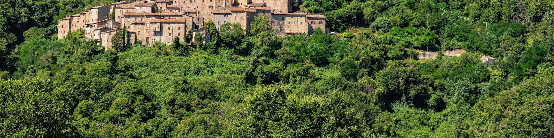 The beautiful village of Castelnuovo Val di Cecina on a sunny summer morning. Province of Pisa, Tuscany, Italy.