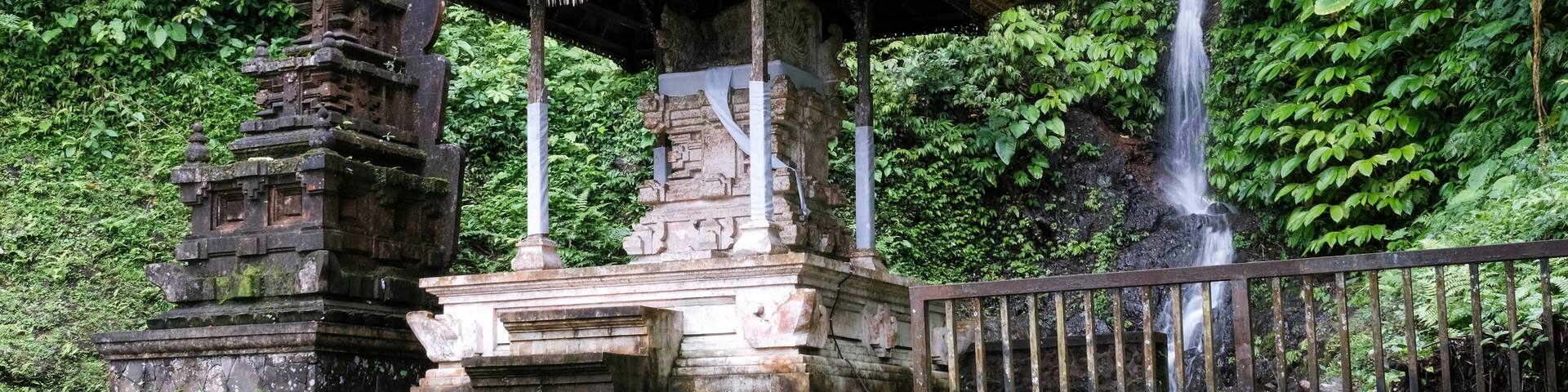 View of Pura Telaga Mas hindu temple and small waterfall on cloudy day. Lempuyang, Bali, Indonesia.