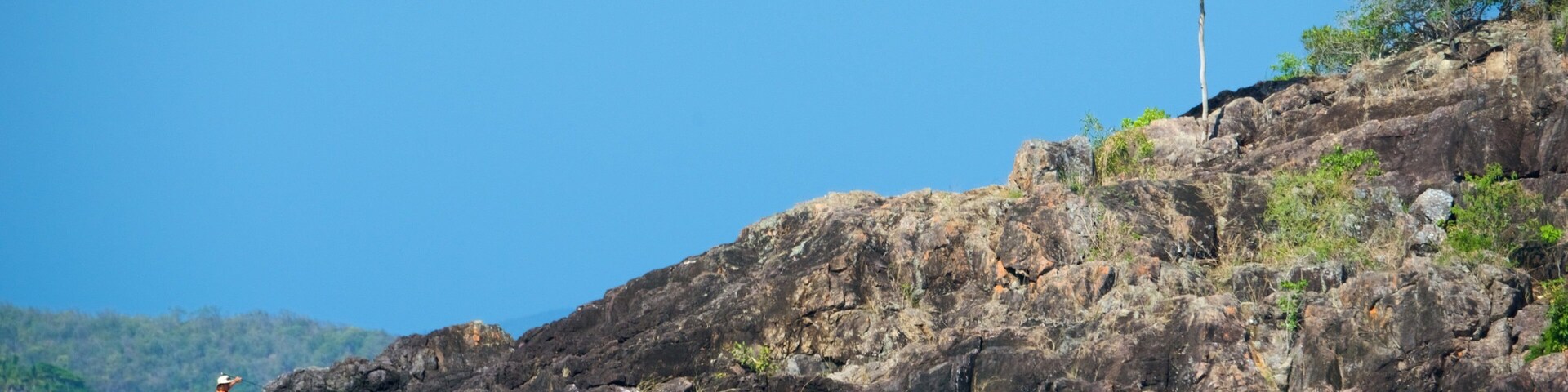 Conway National Park featuring rocky coastline as well as a small group of people
