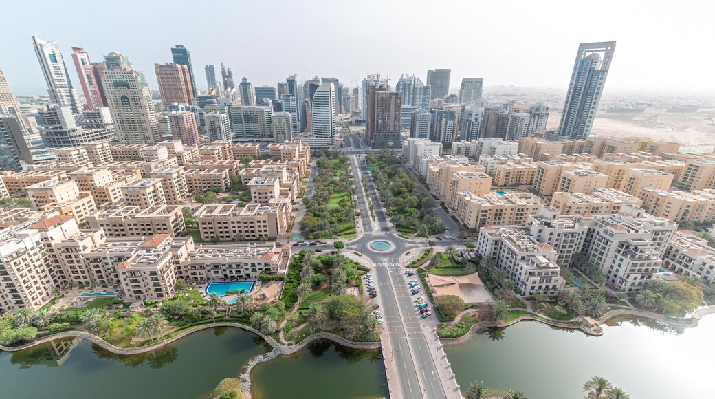 Skyscrapers in Barsha Heights district and low rise buildings in Greens district aerial timelapse. Dubai skyline