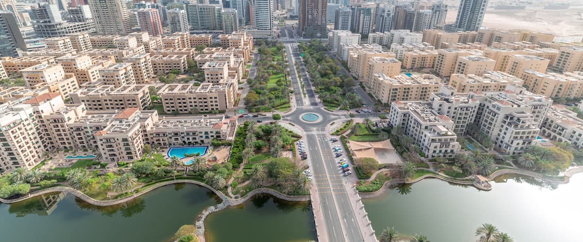 Skyscrapers in Barsha Heights district and low rise buildings in Greens district aerial timelapse. Dubai skyline
