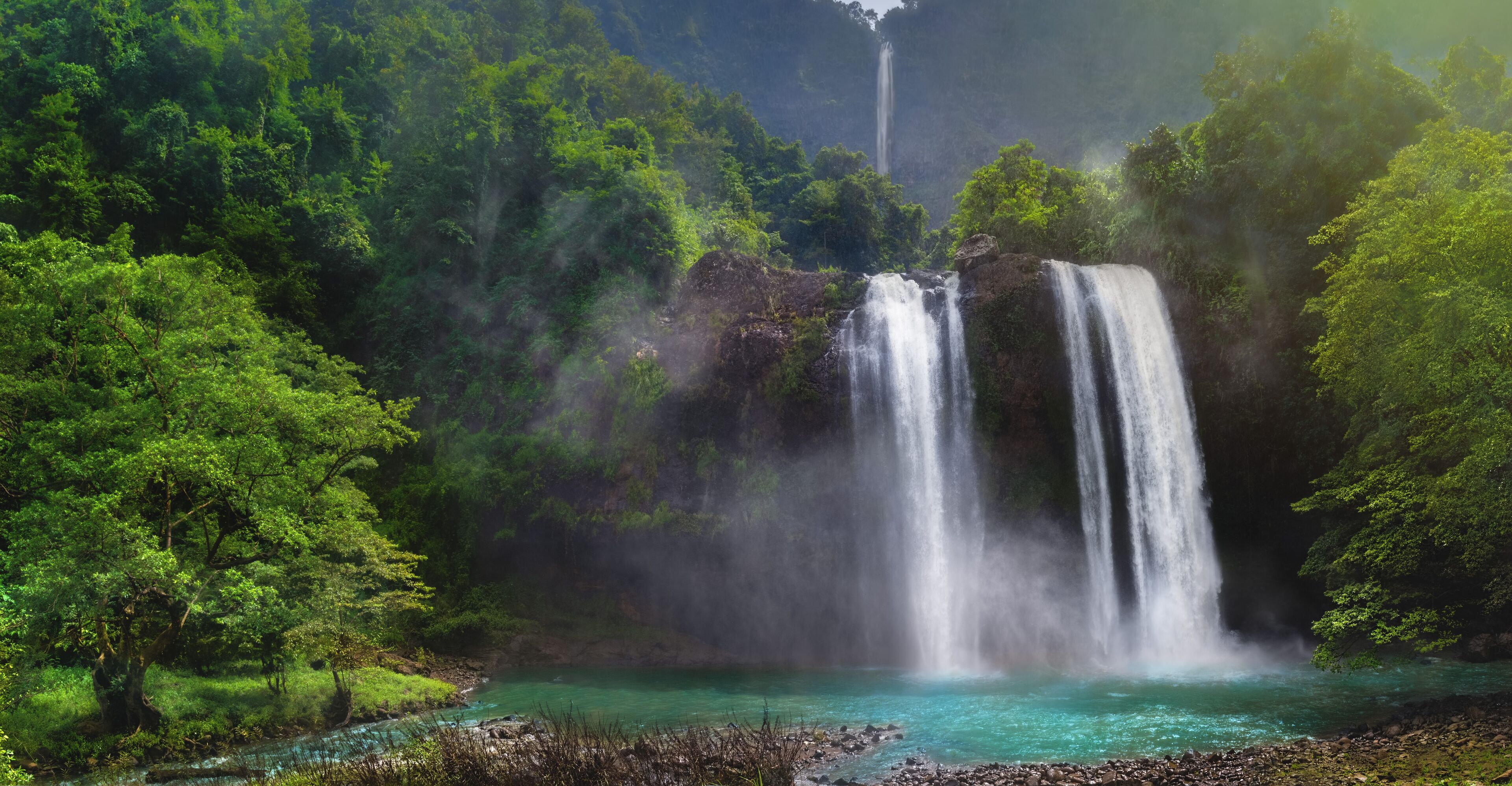 Twin Waterfall Rain Forest In Valley Like A Paradise Garden With Turquoise Green Pond and Blur Waterfall  Mountain Behind. Curug Sodong Amidst Tropical Rain Forest in Global Geopark Ciletuh