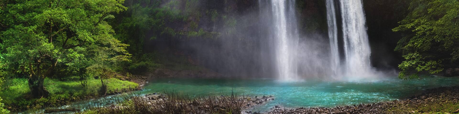 Twin Waterfall Rain Forest In Valley Like A Paradise Garden With Turquoise Green Pond and Blur Waterfall Mountain Behind. Curug Sodong Amidst Tropical Rain Forest in Global Geopark Ciletuh