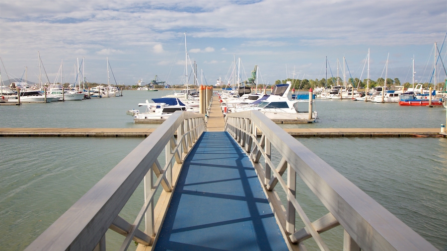 A marina with numerous sailboats docked at the pier.