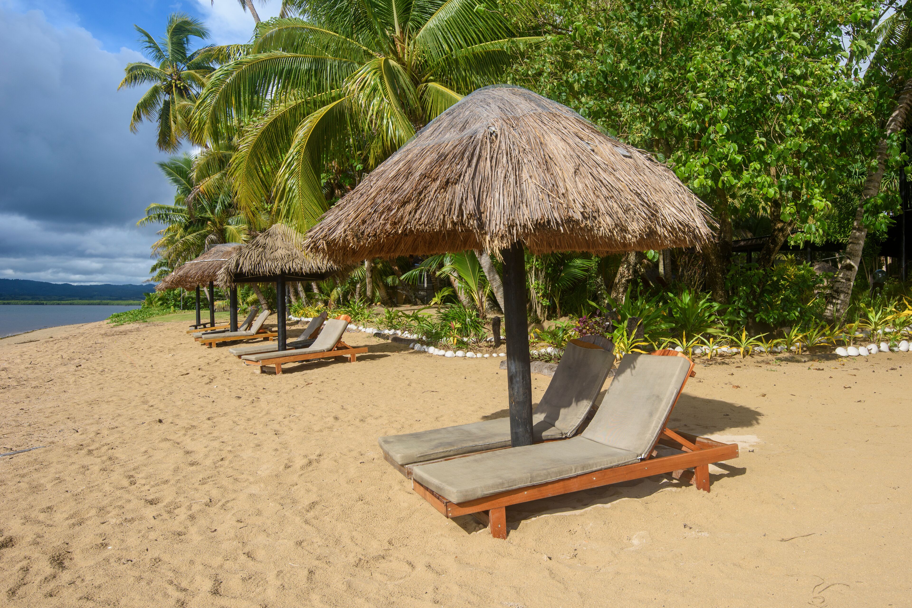 Reclining chairs in front of the beach at Likuri Island, fiji