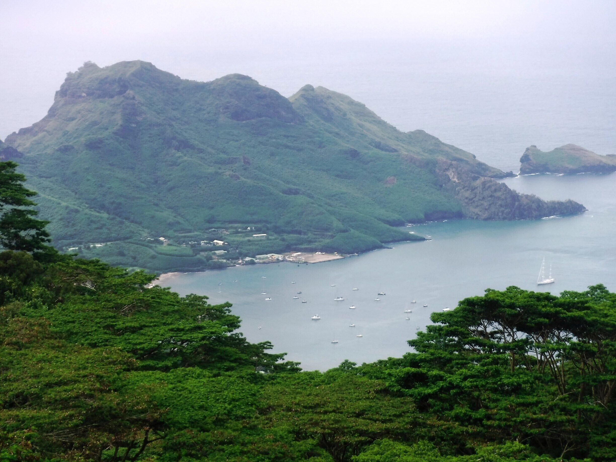The island of Hiva Oa, Marquesas, French Polynesia! The locals will take you on a 4x4 tour of their island to "La Cascade," a beautiful waterfall with a clear pool to swim in -- but first you have to live through the Jeep tour, and hike 30 minutes through the steamy jungle with its hungry mosquitos! 