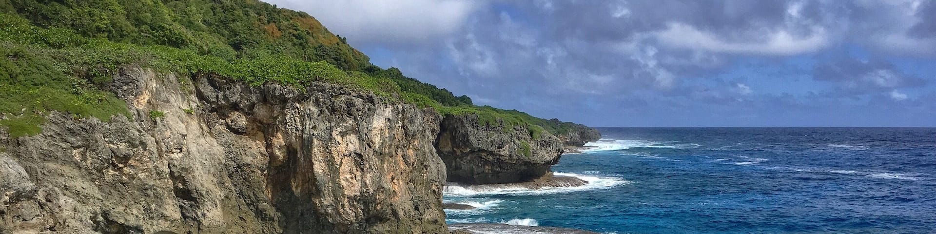There is a short hike through dense jungle to get to the cave and the look out. The cave is a short ways before and after a short swim and squeeze through a small opening you see a pretty large room, completely dark (bring some sort of light source). You can cliff jump from the lookout or just see a beautiful shoreline. #guam