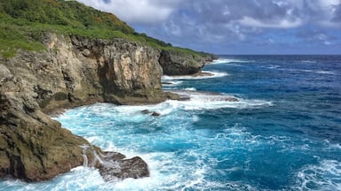 There is a short hike through dense jungle to get to the cave and the look out. The cave is a short ways before and after a short swim and squeeze through a small opening you see a pretty large room, completely dark (bring some sort of light source). You can cliff jump from the lookout or just see a beautiful shoreline. #guam