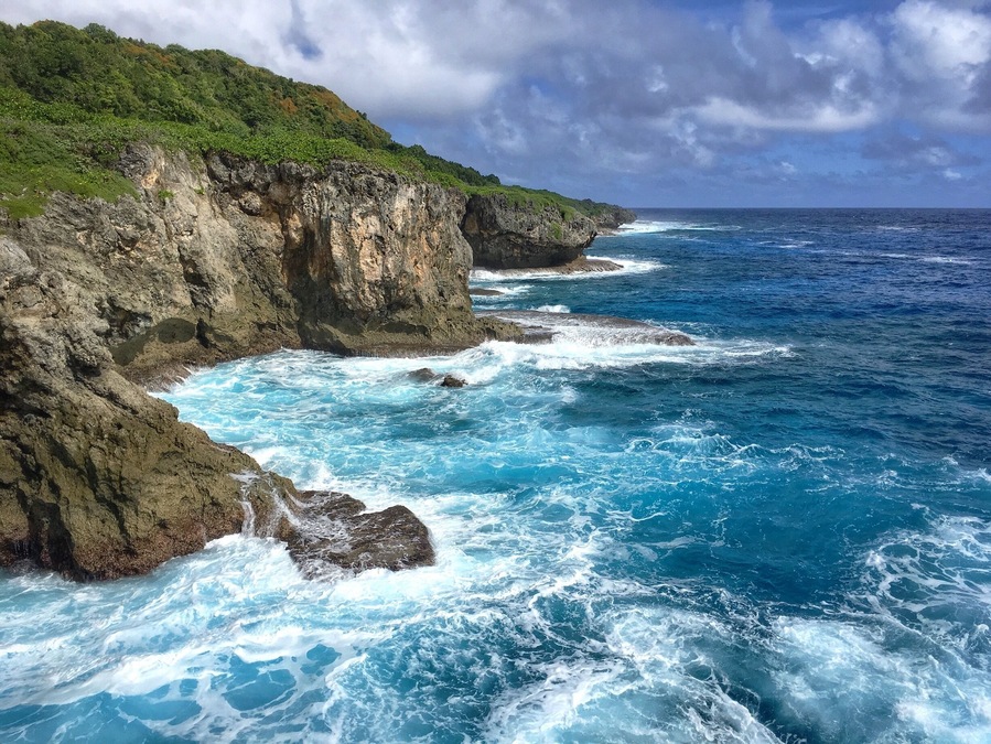 There is a short hike through dense jungle to get to the cave and the look out. The cave is a short ways before and after a short swim and squeeze through a small opening you see a pretty large room, completely dark (bring some sort of light source). You can cliff jump from the lookout or just see a beautiful shoreline. #guam