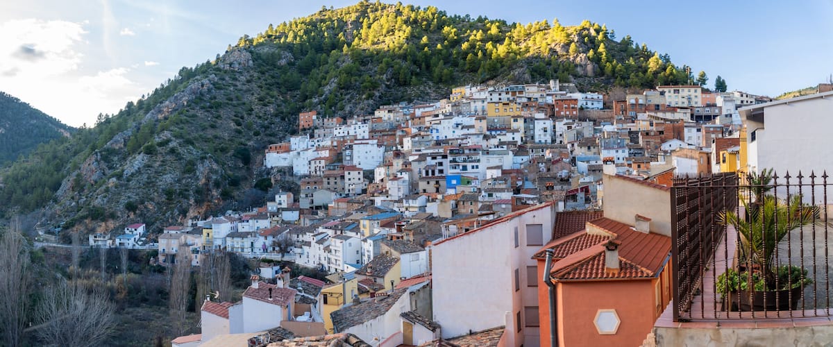 A hillside town with buildings densely packed on a mountain slope.
