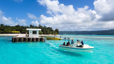 Saipan showing general coastal views and boating as well as a small group of people