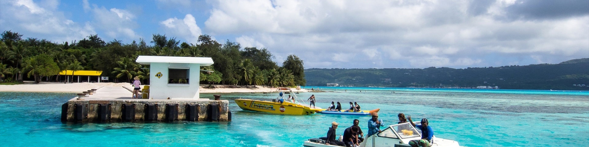 Saipan which includes boating and general coastal views as well as a small group of people