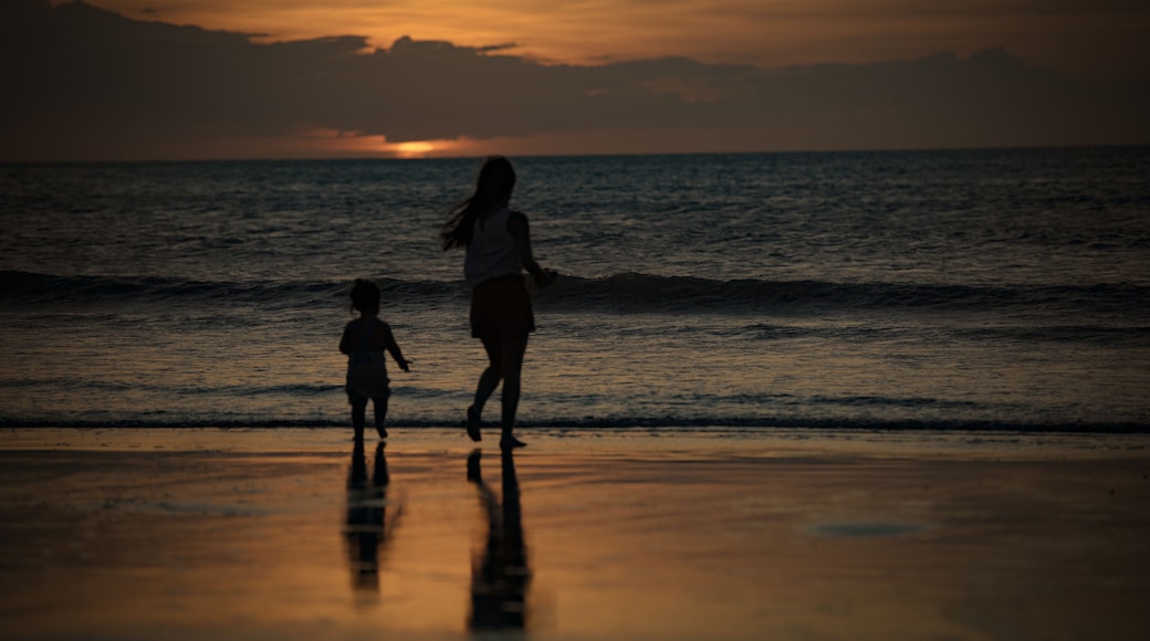 Silhouettes of woman and child at Jericoacoara sunset beach