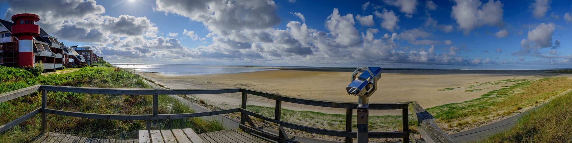 Panorama view of vantage point and promenade along the water's edge around the southernmost tip of the island Amrum in Wittdün, North Frisia, Schleswig-Holstein, Germany.