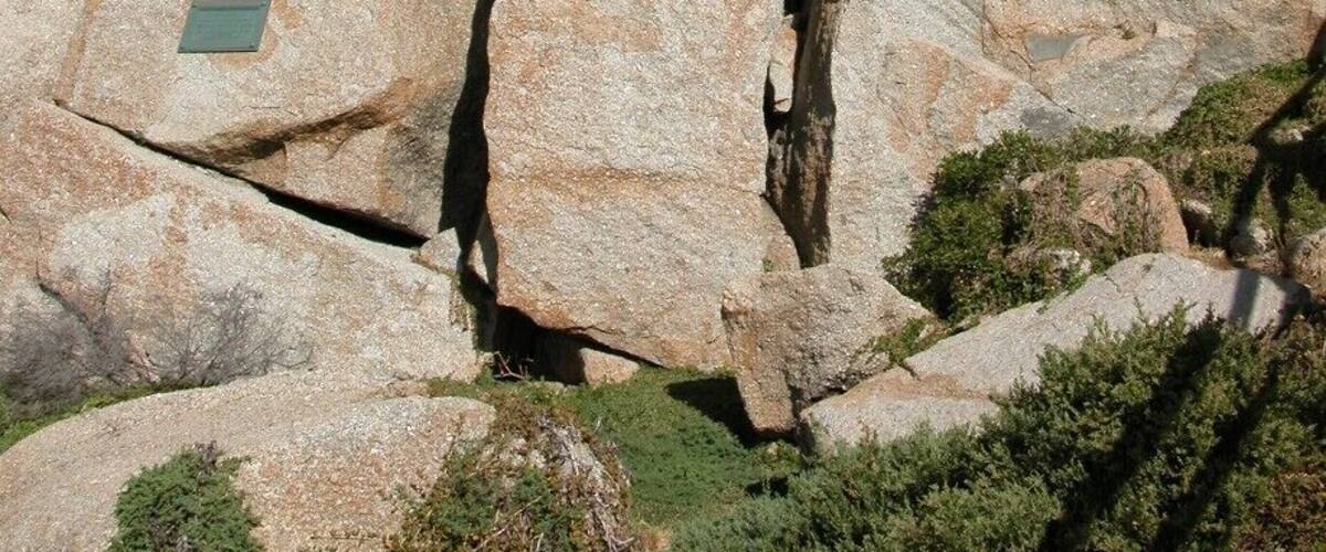 A large rock formation with a plaque.