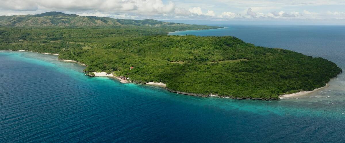 Aerial shots of this Magnificent Island surrounded by calm and deep blue sea water. Siquijor, Philippines.