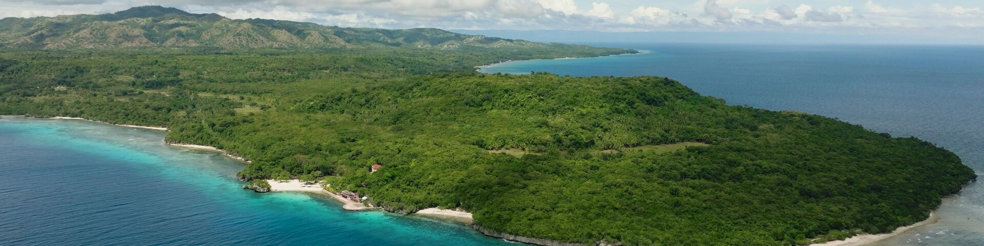 Aerial shots of this Magnificent Island surrounded by calm and deep blue sea water. Siquijor, Philippines.