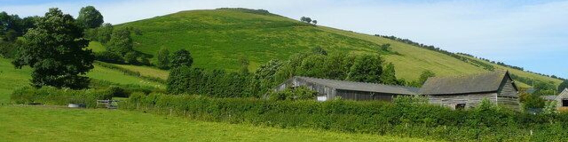 View towards Caer Caradoc The farm buildings are at the east end of the hamlet of Chapel Lawn in the Redlake valley. A high and more visited hill named Caer Caradoc is to the east of All Stretton, giving two hillforts in Shropshire accredited to the early British leader known by the Romans as Caractacus.