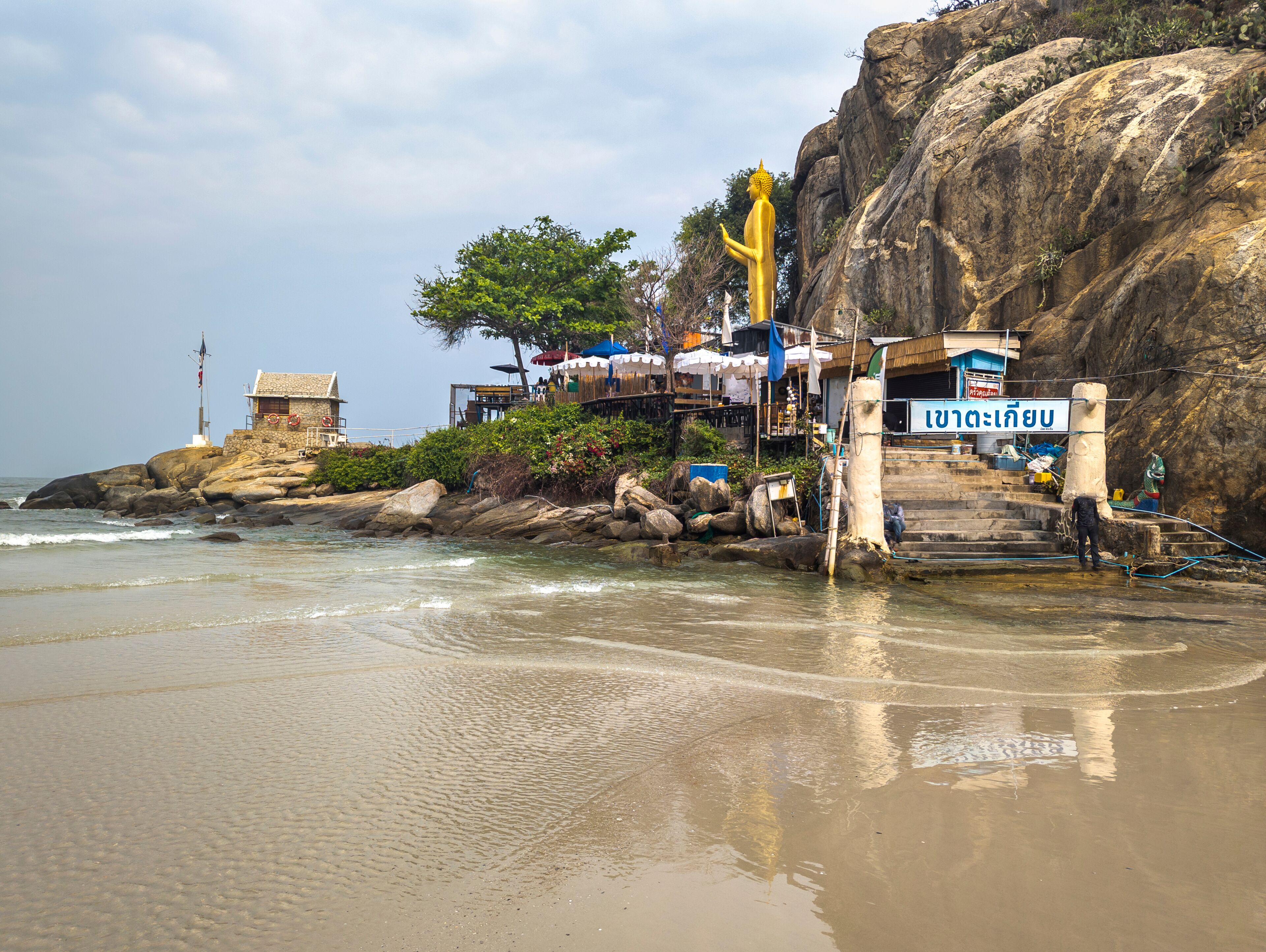 Beautiful Golden Buddha statue,standing on Monkey Mountain, at Khao Takiab Nuea Beach,Hua Hin,Thailand.