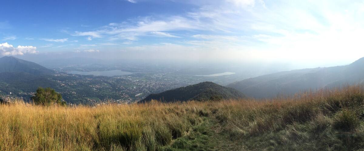 A mountainous landscape with a valley and a lake.